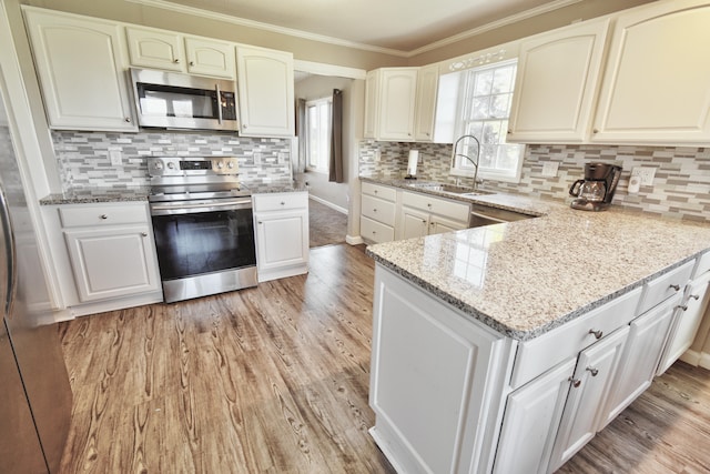 kitchen with sink, white cabinets, and stainless steel appliances