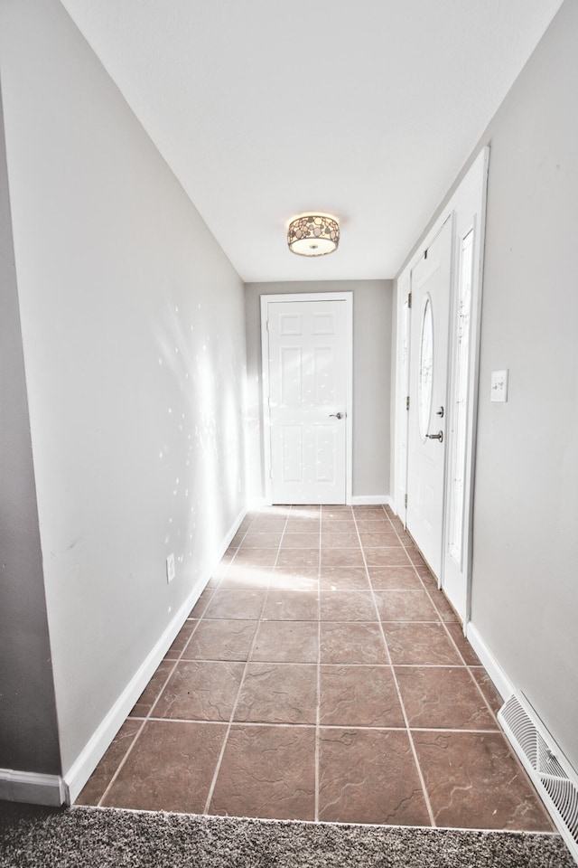 corridor featuring tile patterned flooring