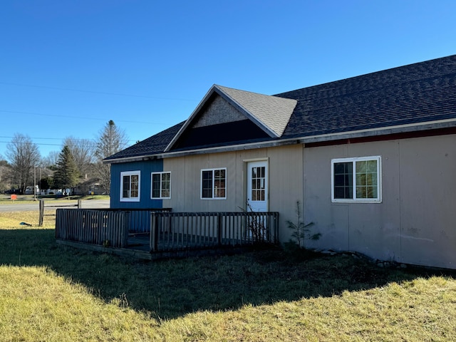 exterior space featuring a yard and a wooden deck