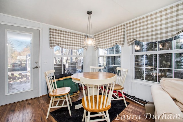 dining area with crown molding and dark hardwood / wood-style flooring