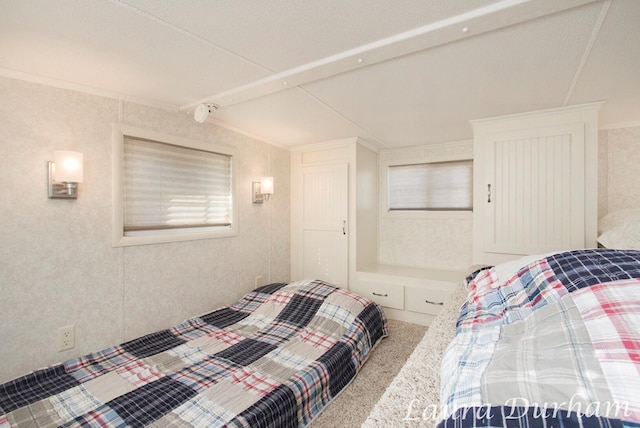 carpeted bedroom with lofted ceiling