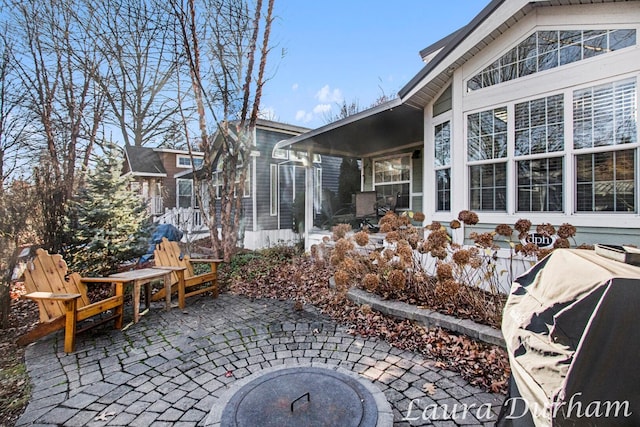 view of patio / terrace with an outdoor fire pit and a grill