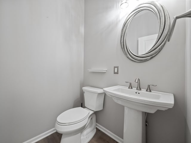 bathroom featuring hardwood / wood-style floors and toilet