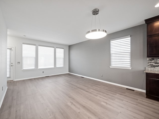 unfurnished dining area with light hardwood / wood-style flooring