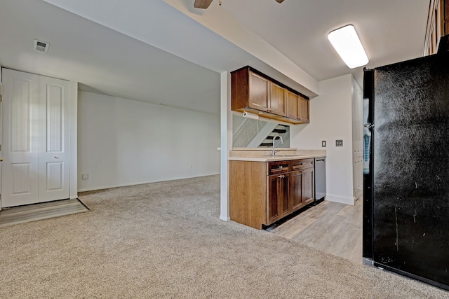 2765 Fox Hollow Ct, Lake Orion, MI 48360 - kitchen featuring freestanding refrigerator, light colored carpet, stainless steel dishwasher, light countertops, and baseboards