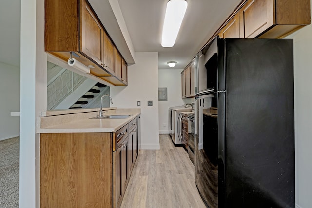 2765 Fox Hollow Ct, Lake Orion, MI 48360 - kitchen with washer and dryer, a sink, freestanding refrigerator, electric panel, and light countertops