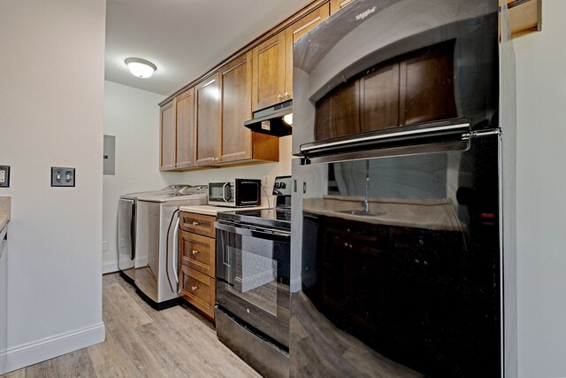 2765 Fox Hollow Ct, Lake Orion, MI 48360 - kitchen with black range with electric cooktop, separate washer and dryer, stainless steel microwave, light wood-style flooring, and electric panel