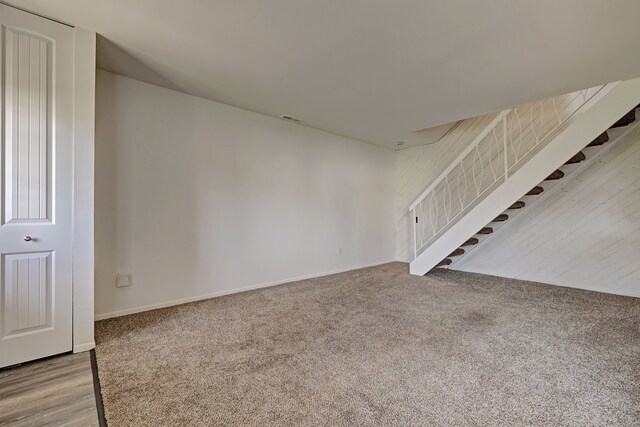 2765 Fox Hollow Ct, Lake Orion, MI 48360 - unfurnished living room with stairway, carpet floors, and baseboards