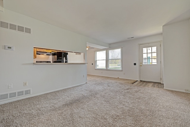 2765 Fox Hollow Ct, Lake Orion, MI 48360 - unfurnished living room with carpet flooring and baseboards