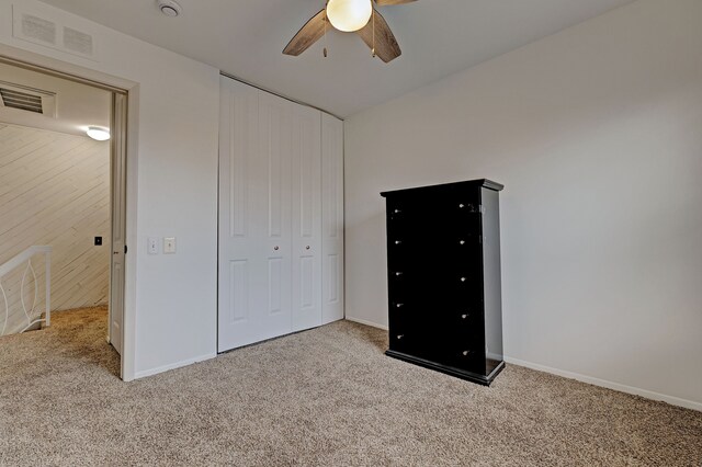 2765 Fox Hollow Ct, Lake Orion, MI 48360 - unfurnished bedroom featuring carpet flooring, a closet, baseboards, and a ceiling fan