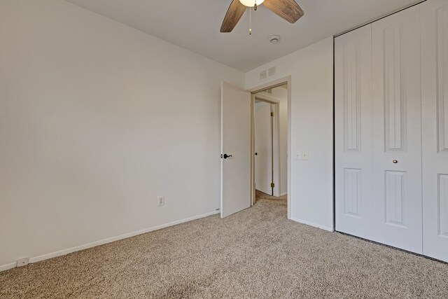 2765 Fox Hollow Ct, Lake Orion, MI 48360 - unfurnished bedroom featuring light colored carpet, baseboards, a closet, and a ceiling fan