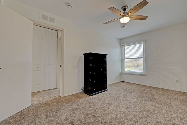 2765 Fox Hollow Ct, Lake Orion, MI 48360 - unfurnished bedroom with carpet, brick wall, and ceiling fan