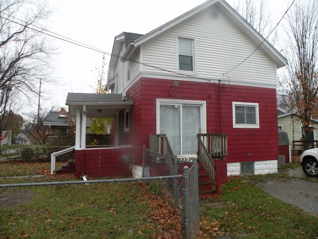 back of property with covered porch