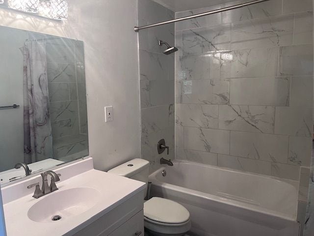 full bathroom with vanity, toilet, and tiled shower / bath