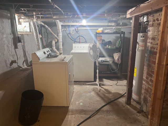 interior space with washer and clothes dryer and gas water heater