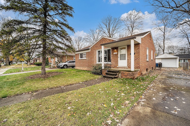 view of front of house with a garage, an outbuilding, and a front yard