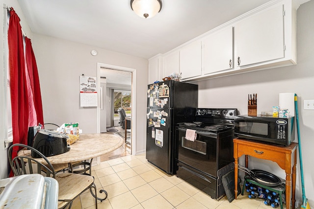 kitchen with light tile patterned floors, white cabinetry, and black appliances