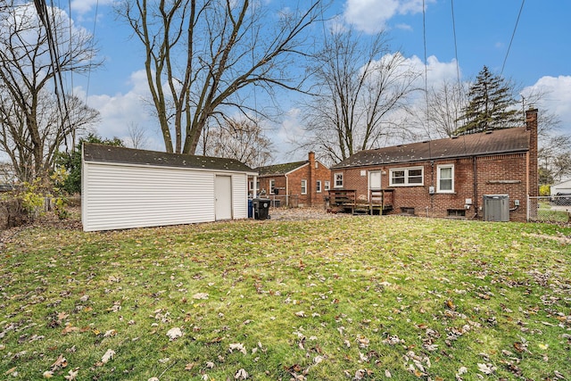 view of yard with central air condition unit, a shed, and a deck