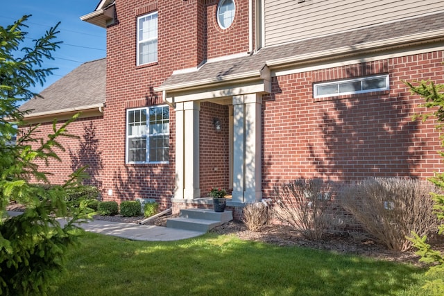 property entrance featuring a lawn