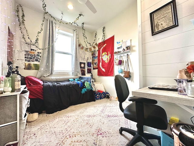 office area with ceiling fan and wooden walls