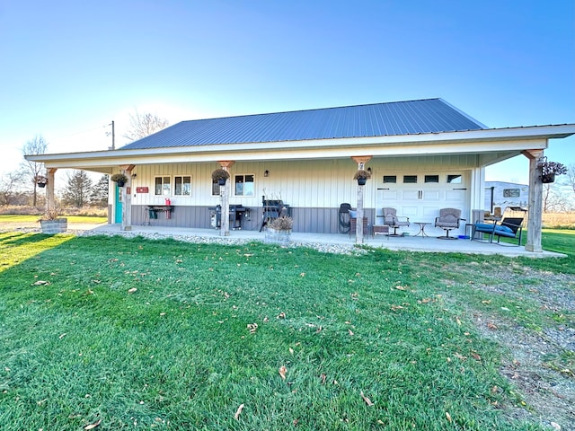 back of property with a lawn