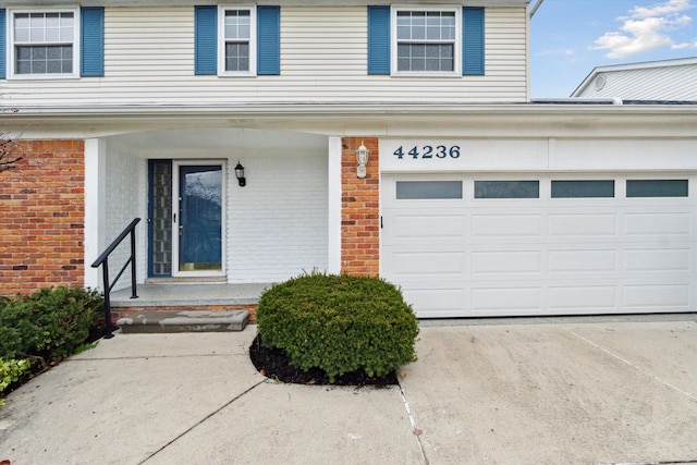 doorway to property with a garage