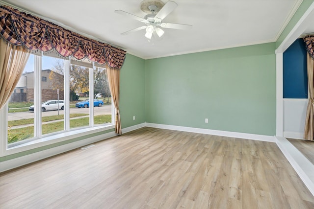 spare room with light wood-type flooring, ceiling fan, and crown molding