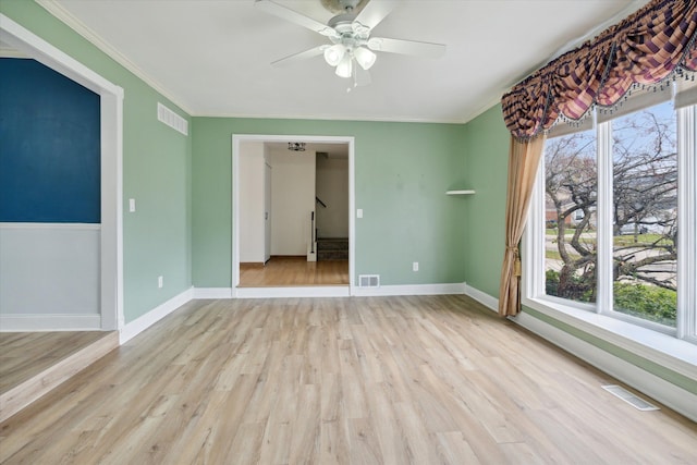 spare room with light hardwood / wood-style floors, ceiling fan, and crown molding