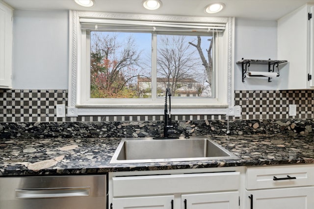 kitchen with backsplash, sink, and white cabinets