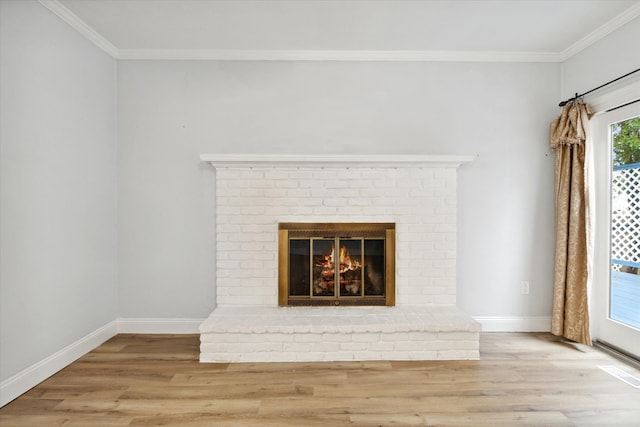 room details featuring wood-type flooring, ornamental molding, and a brick fireplace