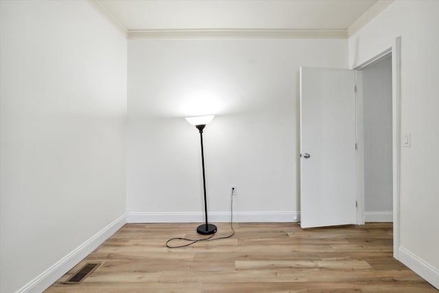 unfurnished room with light hardwood / wood-style floors and ornamental molding