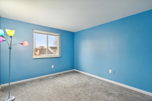 unfurnished room featuring carpet