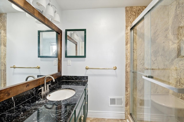 bathroom featuring vanity and an enclosed shower