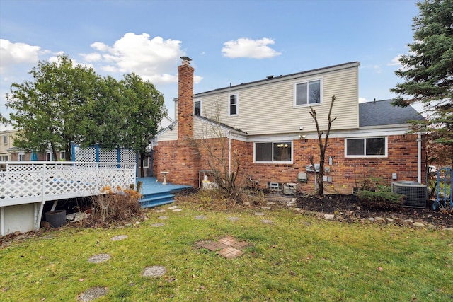 rear view of house featuring cooling unit, a yard, and a wooden deck