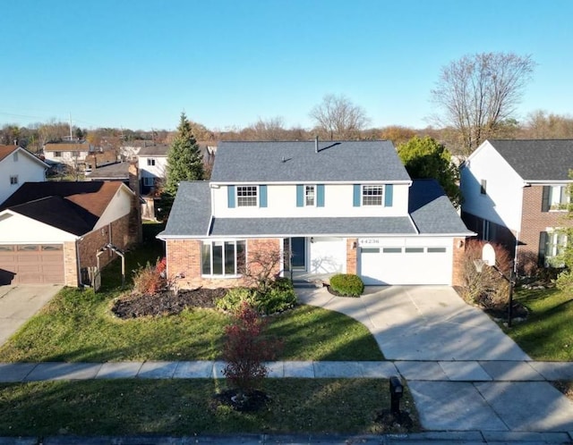 view of front of property with a front yard and a garage