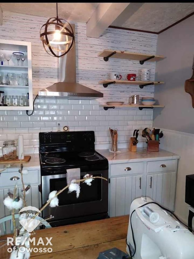 kitchen featuring decorative backsplash, island range hood, electric range, decorative light fixtures, and white cabinetry