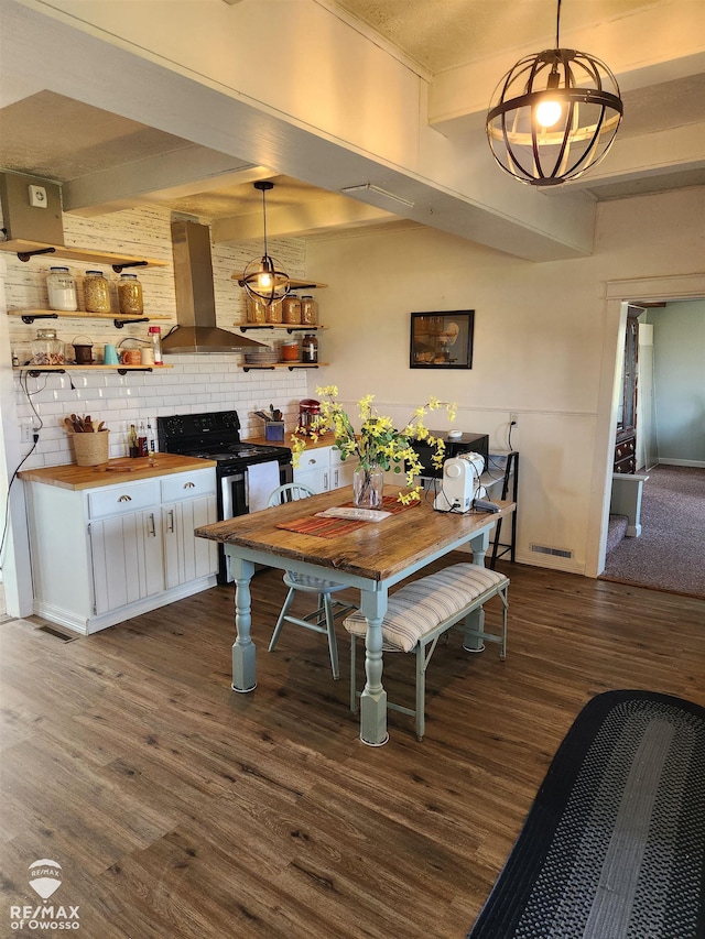 dining area with beamed ceiling and dark wood-type flooring