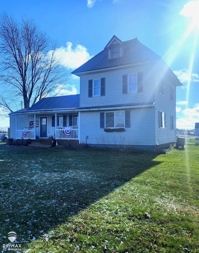 rear view of property with a lawn and covered porch