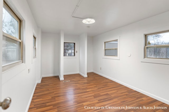 unfurnished room featuring dark wood-type flooring