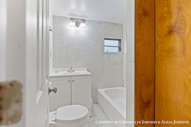 bathroom featuring tile patterned floors, vanity, toilet, and tile walls