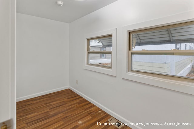 empty room featuring dark hardwood / wood-style flooring