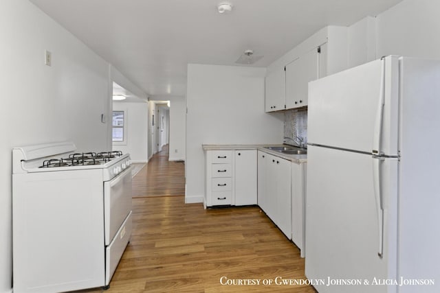 100 Inca Dr SW, Grand Rapids, MI 49548 - kitchen featuring white appliances, a sink, light wood-style flooring, white cabinets, and tasteful backsplash