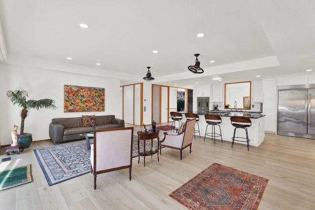 living room with sink and light wood-type flooring