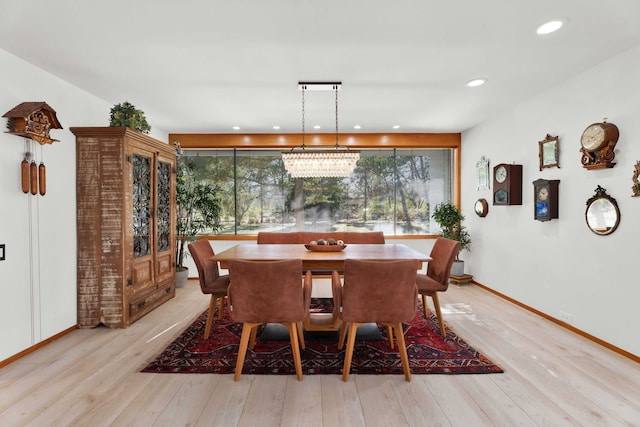 dining area featuring a notable chandelier and light hardwood / wood-style floors