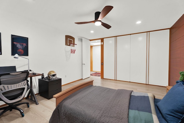 bedroom featuring ceiling fan, light wood-type flooring, and a closet