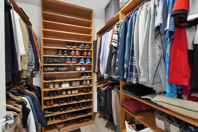 walk in closet with light wood-type flooring