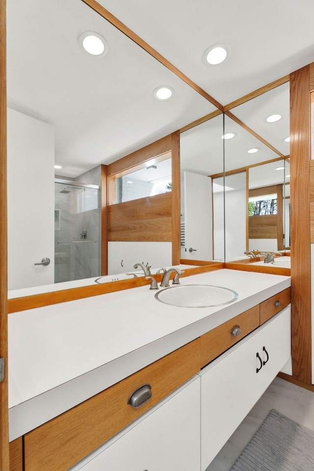 bathroom featuring tile patterned floors, vanity, and an enclosed shower