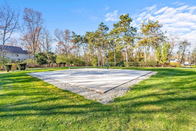 view of pool with basketball court and a yard