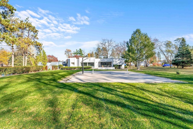 view of yard featuring basketball hoop