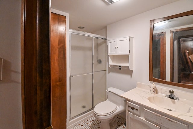 bathroom with walk in shower, vanity, toilet, and tile patterned flooring